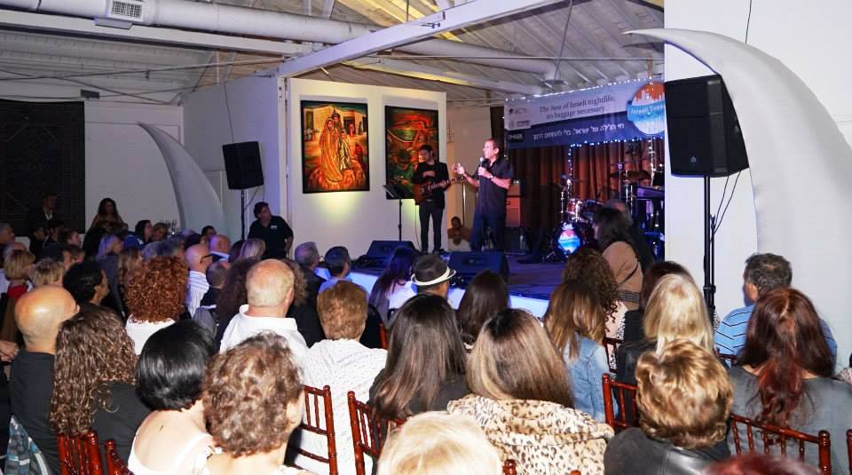 Audience attending a live musical performance during Siona Thacker's art exhibition in Beverly Hills, California.