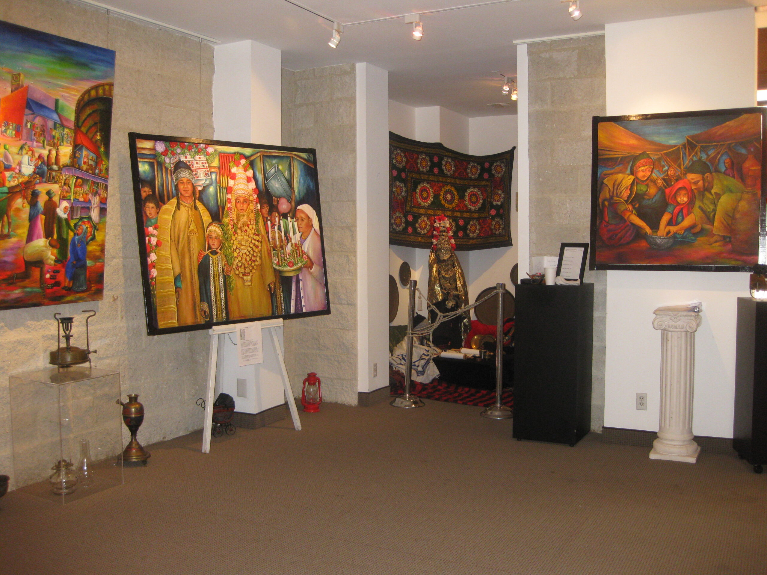 Gallery view of Siona Thacker's solo exhibition in Beverly Hills, California, featuring original paintings and traditional cultural artifacts.