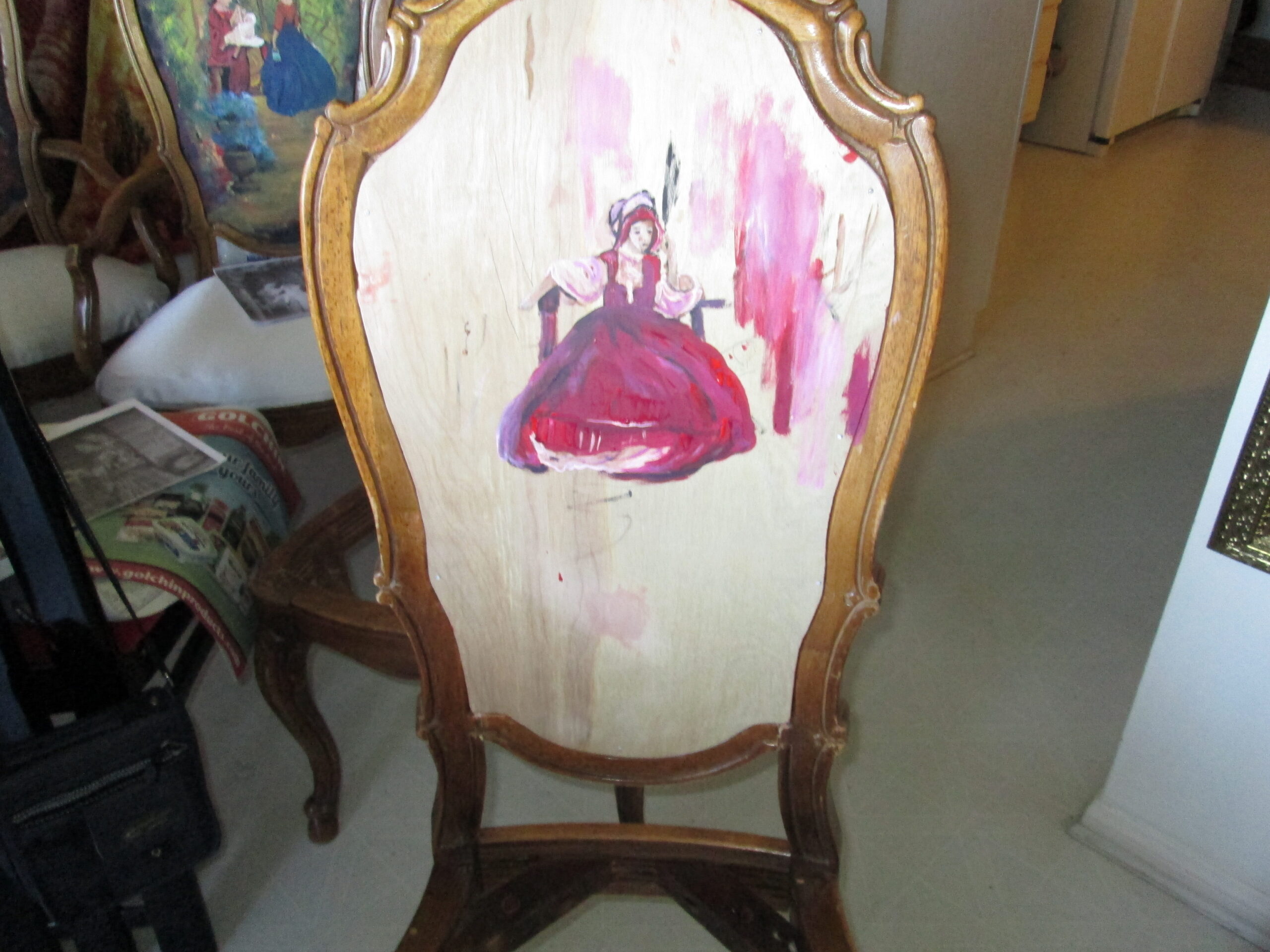 The first brushstrokes of an original painting on a restored antique chair.