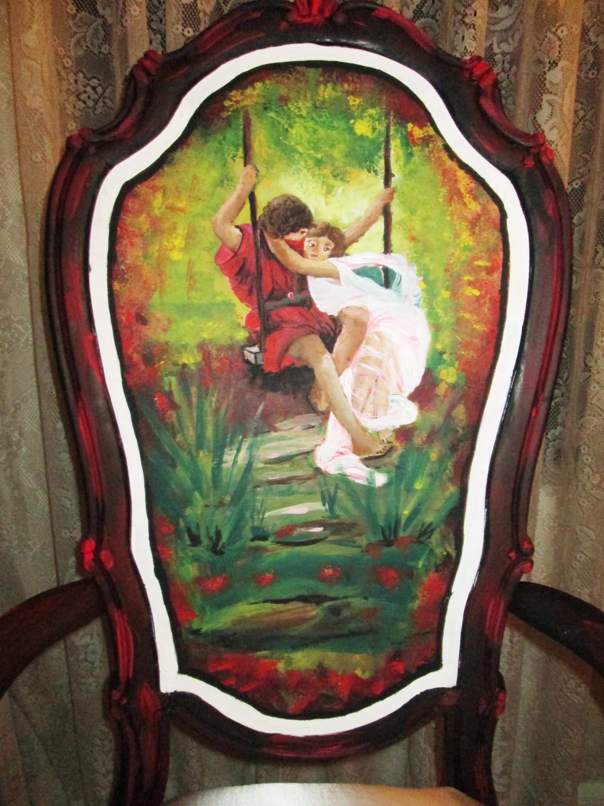 Hand-painted antique chair featuring two children on a swing in a colorful garden.
