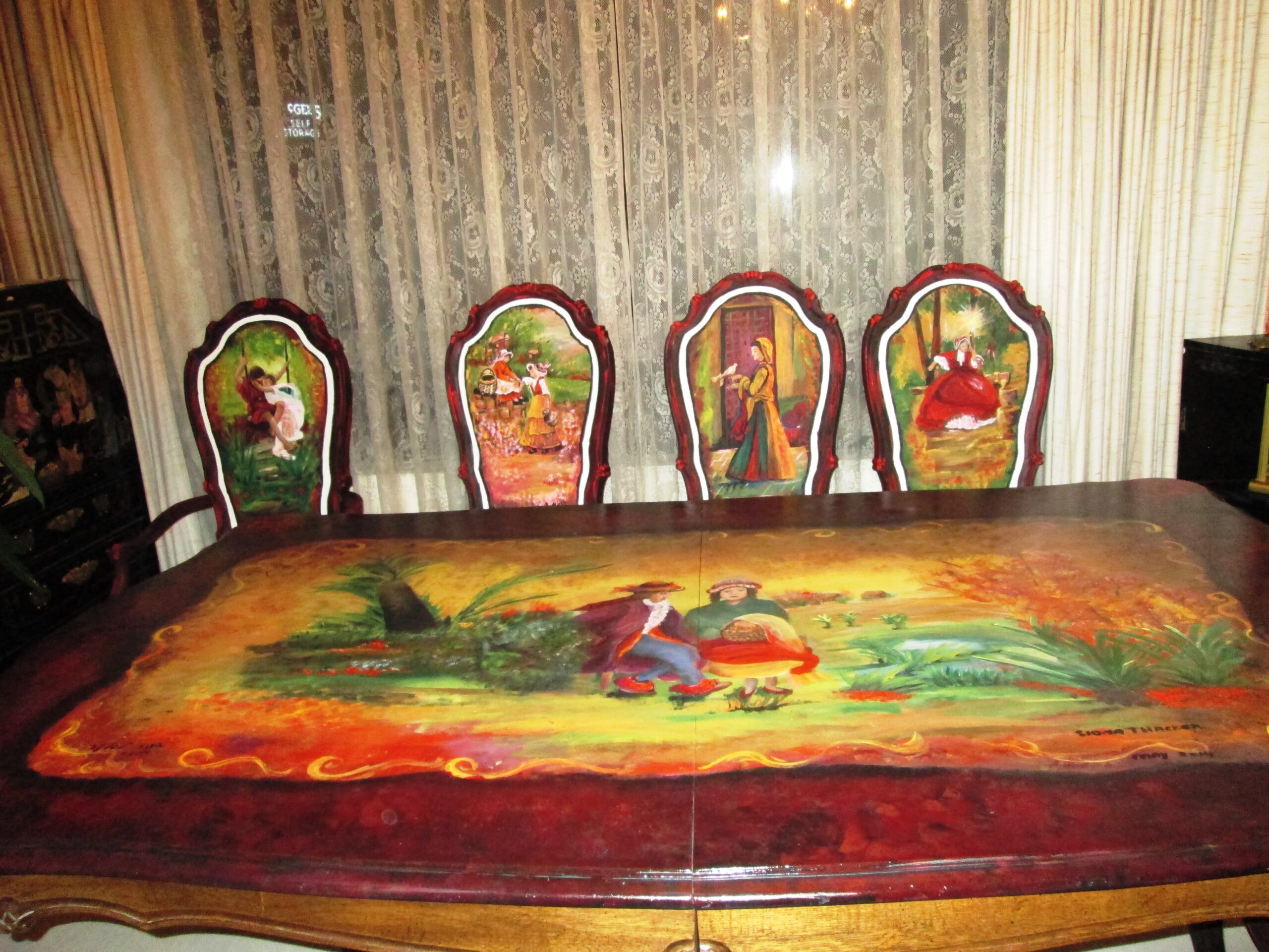 Completed hand-painted antique dining table and chairs featuring original artwork by Siona Thacker